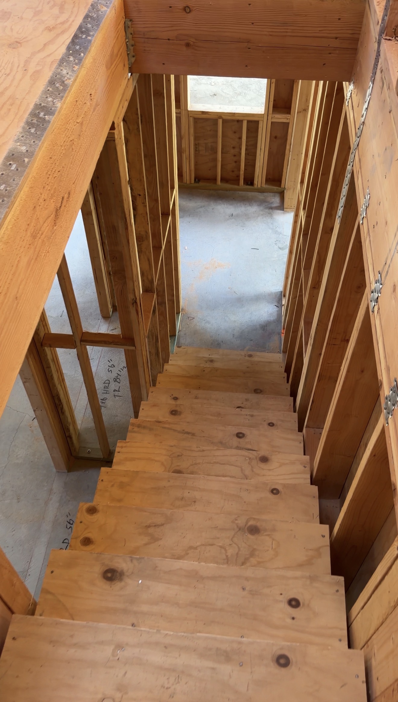Wood stair framing viewed from the upper floor